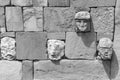 Tiwanaku ancient stone faces figures wall archaeologic site, Bolivia, B&W.