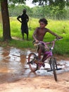 Tiwi Boy Riding a Bicycle