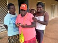 Tiwi Women and Baby Checking Phone Royalty Free Stock Photo