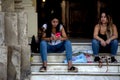 Young ladies sitting on some steps