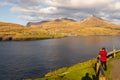 Tourist taking a photo of a beautiful mountain landscape, , Tjornuvik, Faroe Islands