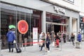 TK Max store shop entrance on shopping high street with queue of people outside