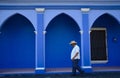 Tlacotalpan, Mexico-February 27, 2023: A man walks down the street past colourful architecture in Tlacotalpan Royalty Free Stock Photo