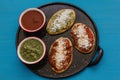 Tlacoyos Mexican food, green and red sauce in Mexico city spicy food mexican culture