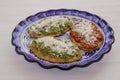 Tlacoyos Mexican food, green and red sauce in Mexico city spicy food mexican culture