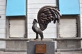 Picture of a bronze sculpture called the rooster man in the downtown
