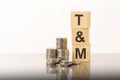 tM - text on wooden cubes on white background with coins Royalty Free Stock Photo