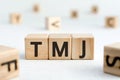 TMJ - acronym from wooden blocks with letters Royalty Free Stock Photo