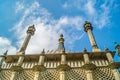 The striking spires of Brighton Pavilion against the backdrop of a bright blue sky.