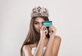 To be beautiful I need my credit card. Fashion model woman pretty girl holding showing plastic bank card smiling happy. Crowned