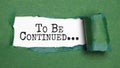 to be continued, text on white paper on torn paper background Royalty Free Stock Photo