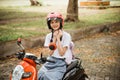 To be safe the student girl tightens the helmet strap