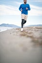 .To Be Young exercise. Healthy active runner running on beach