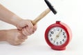 To beat his fist on the red alarm clock Royalty Free Stock Photo