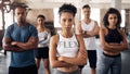 To conquer your goals adjust your mindset. Portrait of a group of confident young people working out together in a gym.