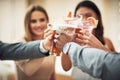 To the coolest clique in town. a group of young friends making a celebratory toast with their drinks in a bar. Royalty Free Stock Photo