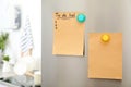 To do list and empty sheet of paper with magnets on refrigerator door in kitchen Royalty Free Stock Photo