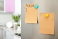 To do list and empty sheet of paper with magnets on refrigerator door in kitchen Royalty Free Stock Photo