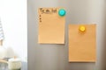 To do list and empty sheet of paper with magnets on refrigerator door in kitchen. Space for Royalty Free Stock Photo