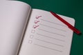 To-do list with several points. Open notebook on green background Royalty Free Stock Photo
