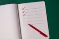 To-do list with several points. Open notebook on green background