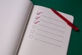 To-do list with several points. Open notebook on green background Royalty Free Stock Photo