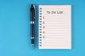 To do list text on notepad on blue background Royalty Free Stock Photo