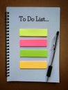 To Do List text on notepad with pen and colorful sticky note. Business concept