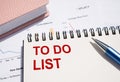 TO DO LIST text written on notepad with pen on financial documents Royalty Free Stock Photo
