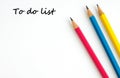 To do list on white paper and pencils background