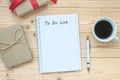 To Do List word with notebook, black coffee cup and pen on wooden table, Top view and copy space. Christmas, Happy New Year New St Royalty Free Stock Photo