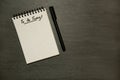 To do today list on gridded spiral notepad with pen, urgent - on dark slate