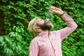 To the dregs. feeling thirsty. drink some water while walking in park. get refreshed. Maintain water balance in the body Royalty Free Stock Photo
