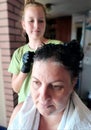 To dye woman& x27;s hair black by her daughter Royalty Free Stock Photo