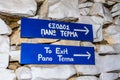 To Exit Pano Terma Funny Blue Signs Attached on the Stone Wall in Syros Island, Greece. Exit is All the Way Up on the Right.