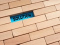 To find a solution concept. The word solution surrounded by wooden blocks