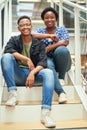 To get to the top youll have to get past us. Portrait of a young businessman and businesswoman sitting on the steps of a Royalty Free Stock Photo