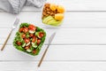 To-go box with salad and fruit for lunch on white wooden background top view copyspace Royalty Free Stock Photo