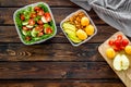 To-go box with salad and fruit for lunch on wooden background top view copyspace Royalty Free Stock Photo
