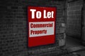 To let with commercial property written on a sign attached to a brick wall Royalty Free Stock Photo