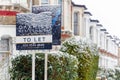 To Let sign covered by winter snow in London