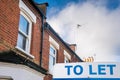 To let sign in front of a property Royalty Free Stock Photo