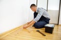 To make repairs. Installing a new skirting board. Royalty Free Stock Photo