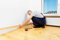 To make repairs. Installing a new skirting board. Royalty Free Stock Photo