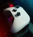 To the mancave. High angle shot of a console remote on a desk in a dark gaming room. Royalty Free Stock Photo