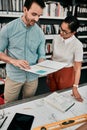 On to the next project. two aspiring young architects looking at a notebook working together in a modern office.