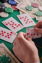 To a poker player in a casino, a combination in straight flush cards, a lot of money and chips Royalty Free Stock Photo