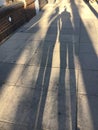 To shadows walking on a sunny sidewalk Royalty Free Stock Photo