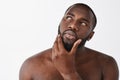 To shave or not, that is question. Thoughtful good-looking masculine African American with beard, standing naked over