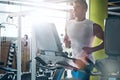 To surpass your limits is to conquer yourself. a young man working out alone in the gym.